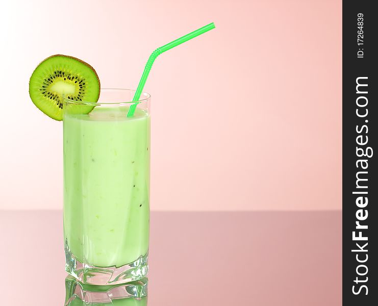 Kiwi juice in a glass on a pink background