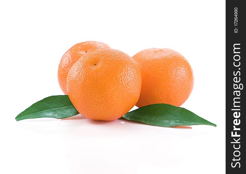 Mandarins isolated and green leaves on white background