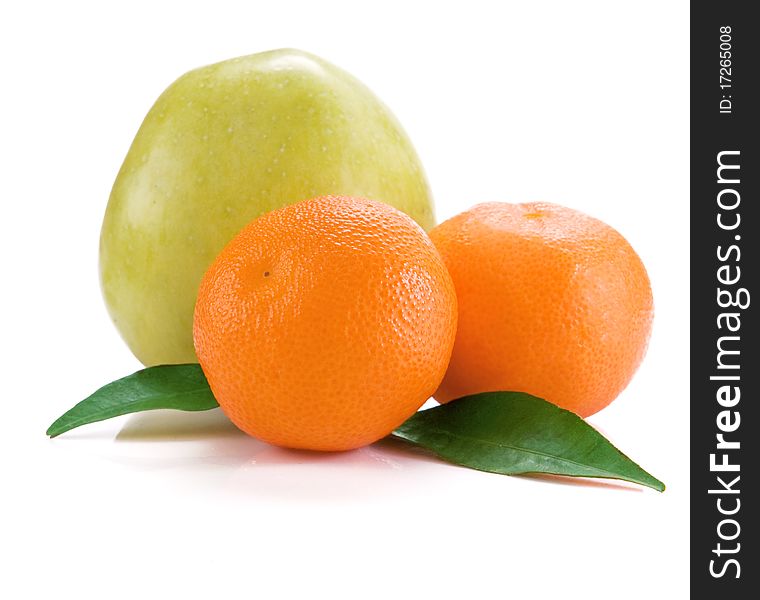 Mandarins and apple isolated and green leaves on white background. Mandarins and apple isolated and green leaves on white background