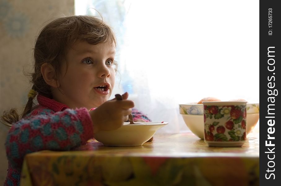 Garden house. Funny little girl for lunch