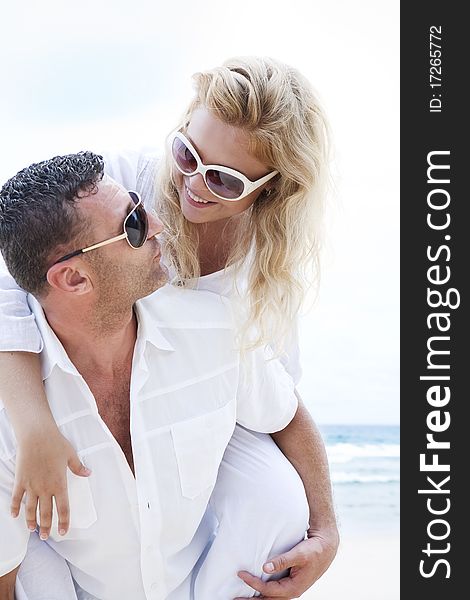 Portrait of young nice couple having good time on the beach. Portrait of young nice couple having good time on the beach