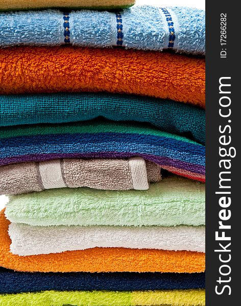 Pile of bright color towels isolated on withe background. Pile of bright color towels isolated on withe background