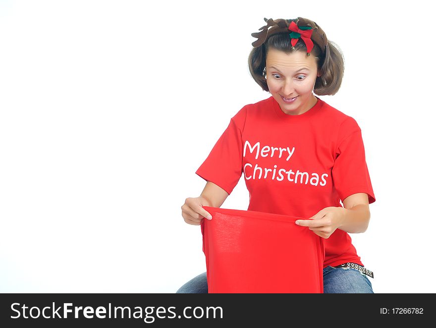 Surprised young woman looks into a Santa's Bag with gifts