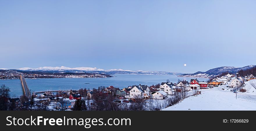 Moon over Finsnes. A typical Norwegian winter landscape. Moon, a bridge, the polar night.