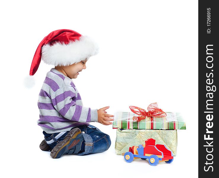 Studio shot of little boy wearing Santa’s hats