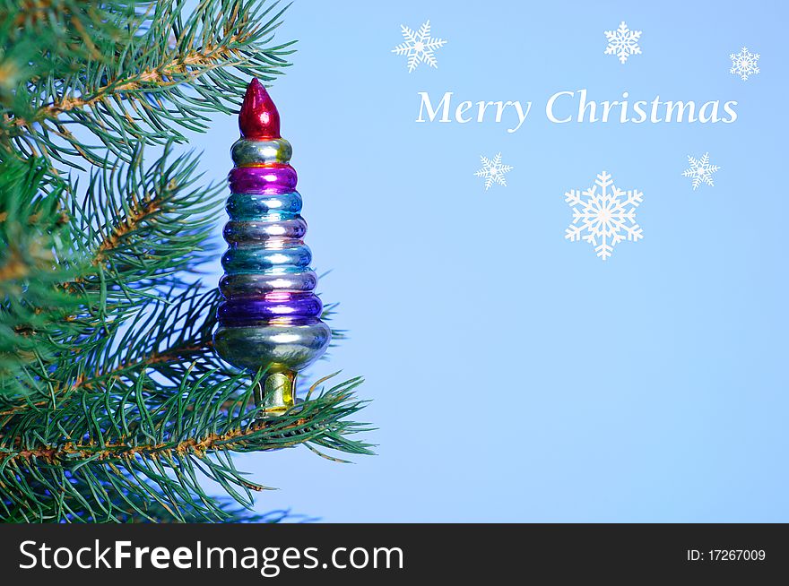 Christmas card. Vintage Christmas Toy on the branches of a Christmas tree