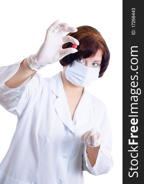 Doctor looking at red pill isolated on white. Doctor looking at red pill isolated on white