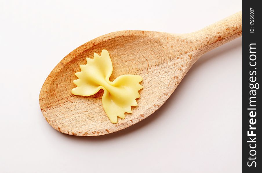 Bowtie pasta on a wooden spoon - studio