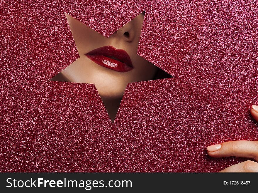 Sexy female lips in a star-shaped cutout.