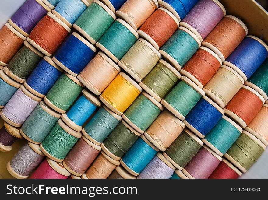 Rolls of colorful threads, close-up and top view.