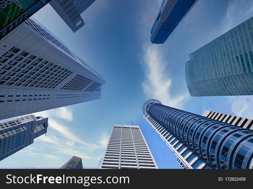 Low angle view of singapore financial buildings at bright sunny day