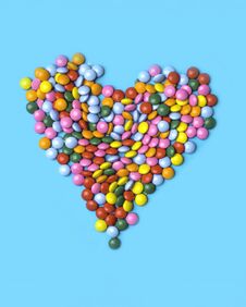 Colorful Candies Arranged As Heart On Blue Background For Valentines Day, Birthday, Party Card Stock Image