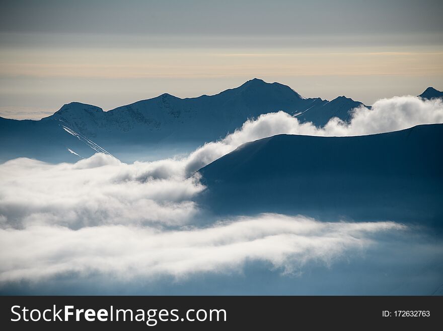 Mountain Tops Peeking Out From The Clouds