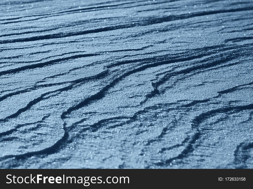 Classic Blue background. Color of the year 2020. Texture of the snow. Snow close-up. Natural snow background