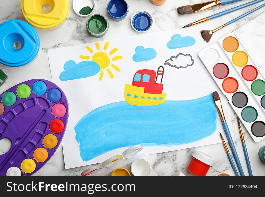 Flat lay composition with child`s painting of ship on white marble table