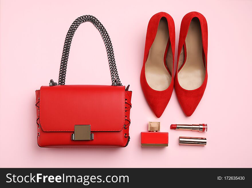 Flat lay composition with stylish woman`s bag and accessories on pink background
