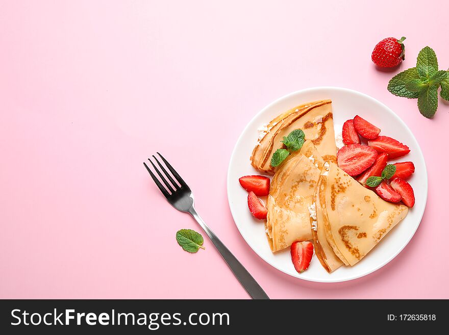 Delicious thin pancakes with strawberries and cottage cheese on pink background, flat lay. Space for text