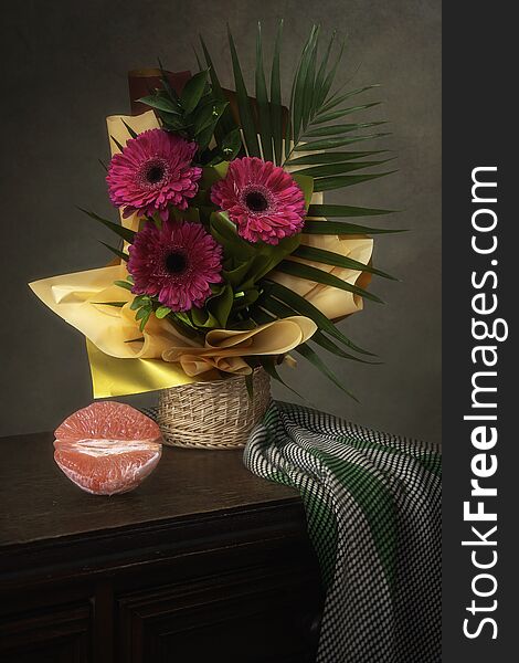 Still life with a beautiful bouquet of gerberas in a gift wrapper