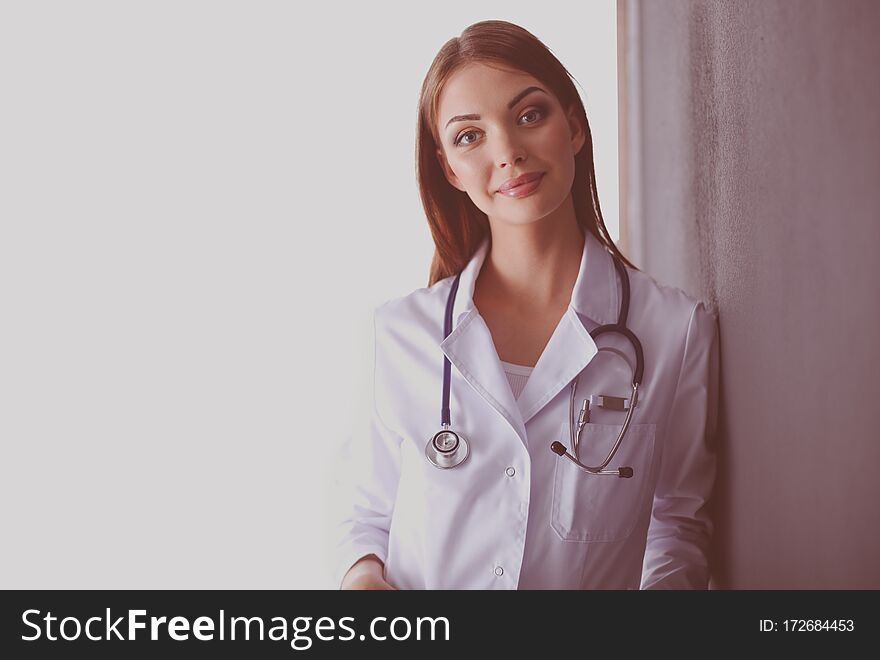 Portrait of female doctor standing against isolated on white background. Woman doctor.
