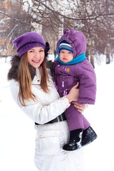 Mother Holding A Baby, Snow, Winter Park Royalty Free Stock Image