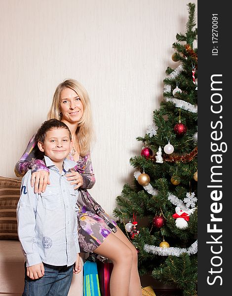 Happy mother with a son near a new-year tree. Happy mother with a son near a new-year tree