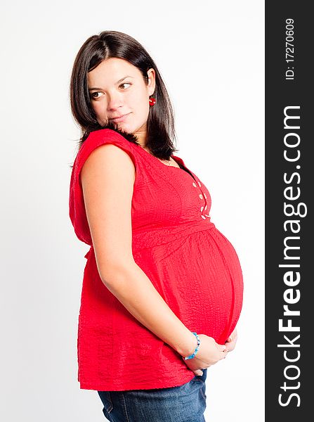 Beautiful pregnant woman staing on light grey background