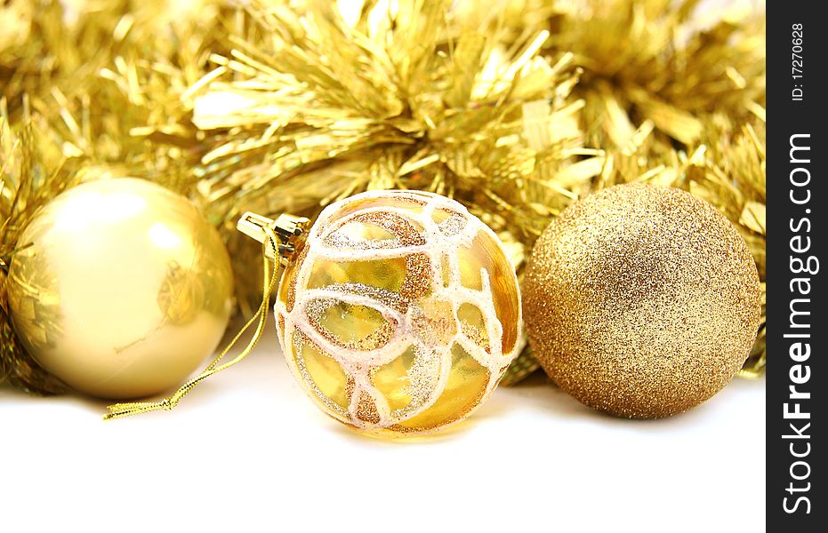 New Year's ornament gold full-spheres lie on a gold background. New Year's ornament gold full-spheres lie on a gold background