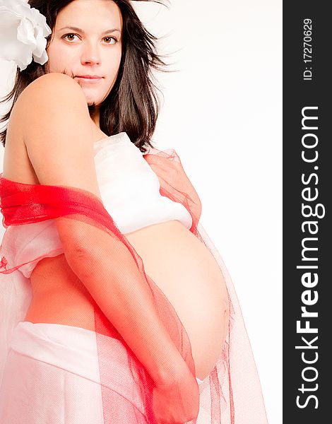 Beautiful pregnant woman staing on light grey background, close up