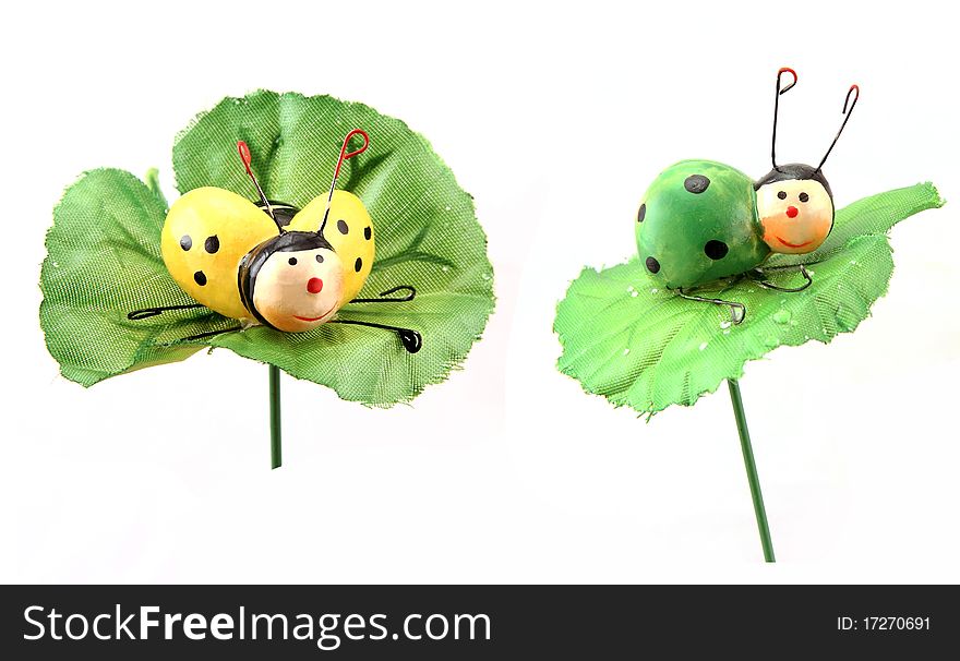 Ornament for colors a yellow and green bug sit on green leaves. Ornament for colors a yellow and green bug sit on green leaves