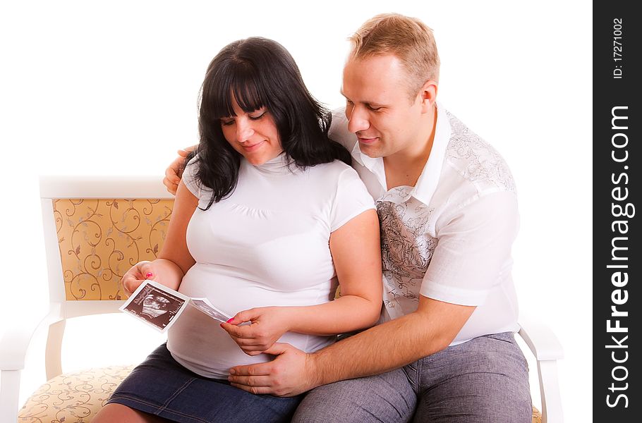 Beautiful young couple holding a sonogram of their unborn child. Beautiful young couple holding a sonogram of their unborn child