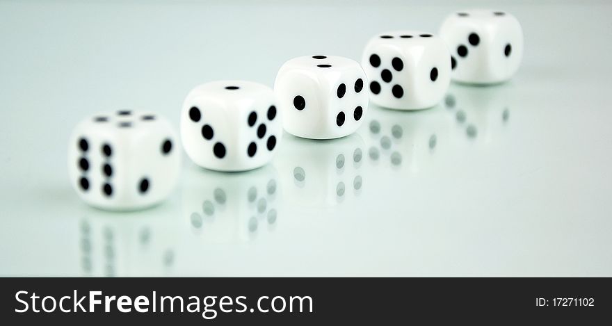 Classic white game dice with a nice reflection.