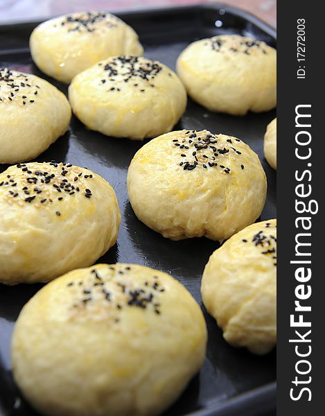 Close up of unbaked homemade buns with sesame top. Close up of unbaked homemade buns with sesame top.