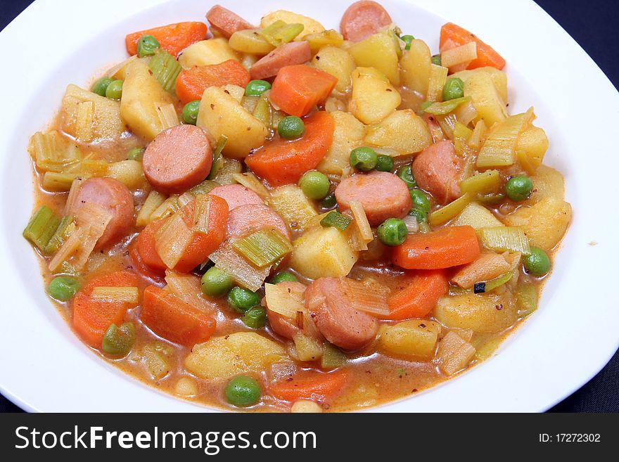 Potato stew with beans on white plate