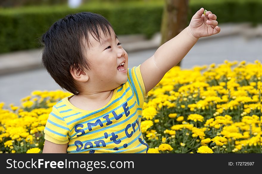 Happy baby is playing in a garden