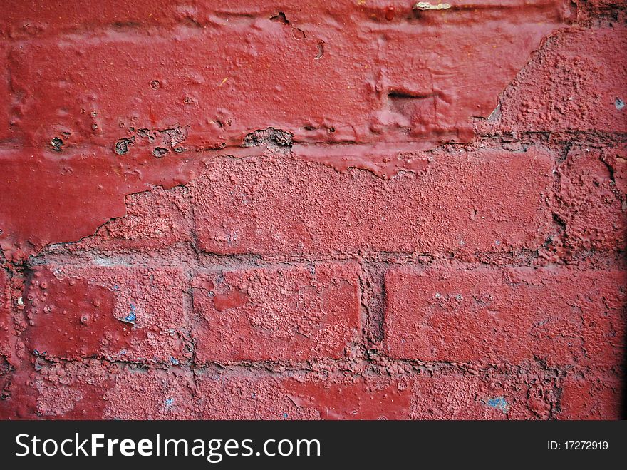 A brick wall painted red. A brick wall painted red