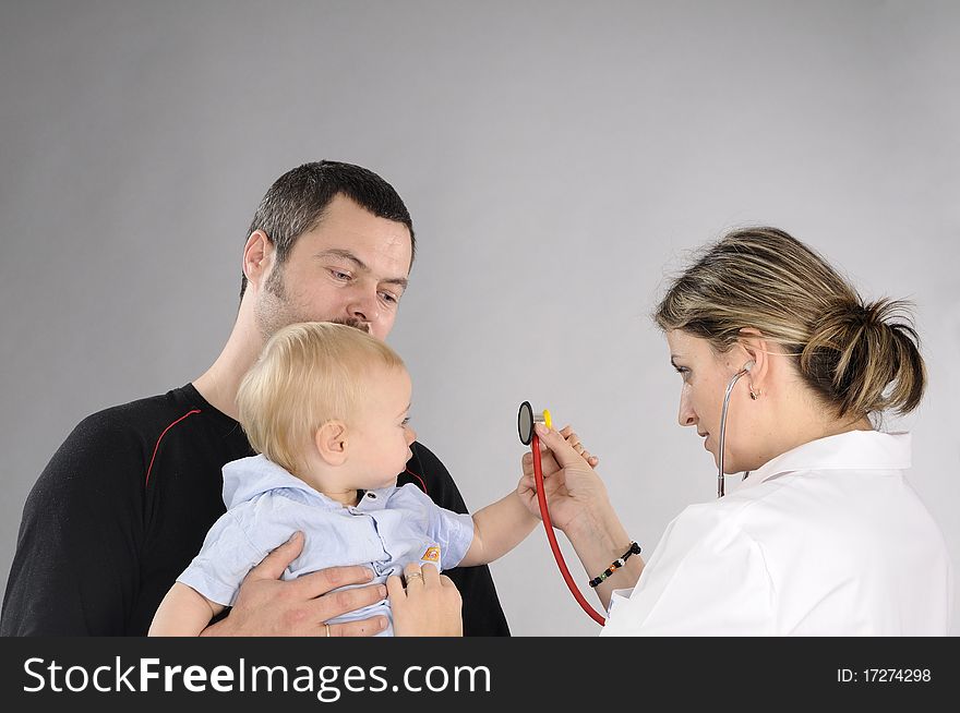 Young doctor preparing to make examination with stethoscope to baby boy. Young doctor preparing to make examination with stethoscope to baby boy