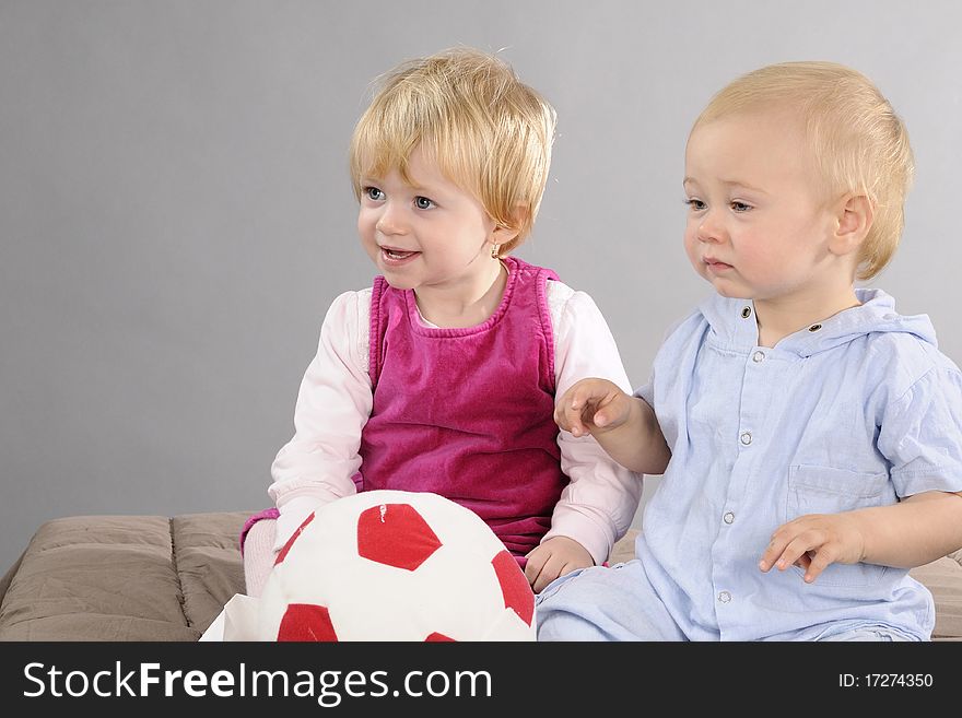 Beautiful baby boy  and girl having fun with ball. Beautiful baby boy  and girl having fun with ball