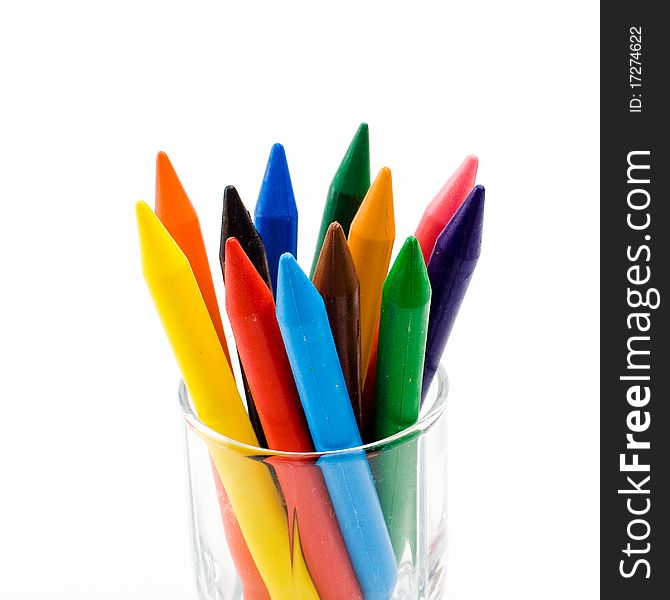 Color pencils stand in a transparent glass. Color pencils stand in a transparent glass