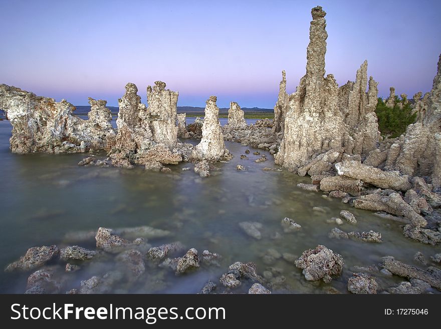 Ancient formations of tufa rocks at Mono Lake in California. The landscape looks like it is on the moon, and the environment is relatively harsh.