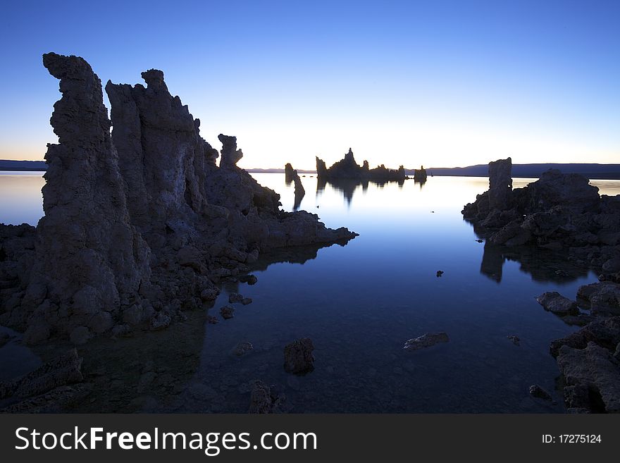 Ancient formations of tufa rocks at Mono Lake in California. The landscape looks like it is on the moon, and the environment is relatively harsh.