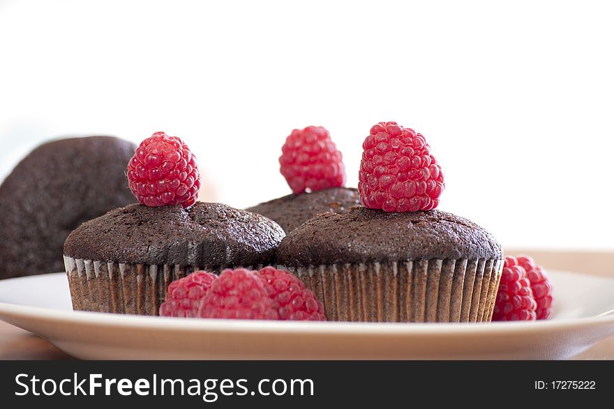 Brown muffins with raspberry close up
