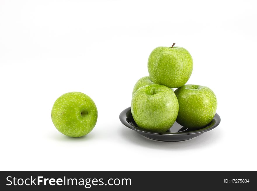 Fresh green apple on plate isolated on white background. Fresh green apple on plate isolated on white background