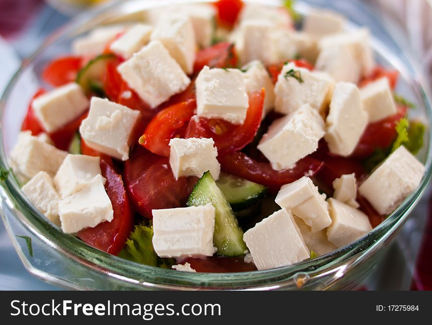 Greek salad - fresh vegetables and soft cheese in a bowl. Greek salad - fresh vegetables and soft cheese in a bowl