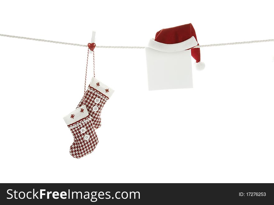 Christmas stockings hanging on a rope hanging next to a sheet of white paper out there can write a test congratulations. Christmas stockings hanging on a rope hanging next to a sheet of white paper out there can write a test congratulations