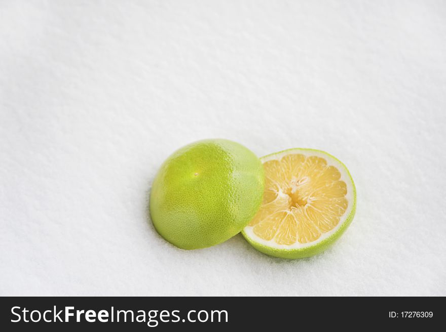 Grapefruit with white snow background, with natural sunlight. Grapefruit with white snow background, with natural sunlight