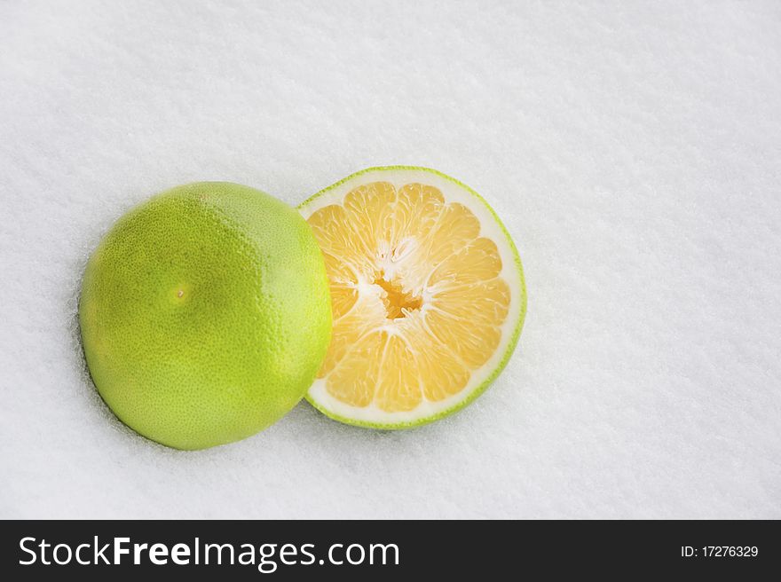 Grapefruit with white snow background, with natural sunlight. Grapefruit with white snow background, with natural sunlight