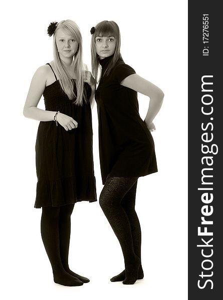 Two girls in black dresses with a white background (black and white). Two girls in black dresses with a white background (black and white)