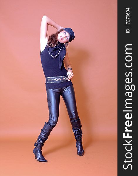 Attractive fashion model wearing leather pants