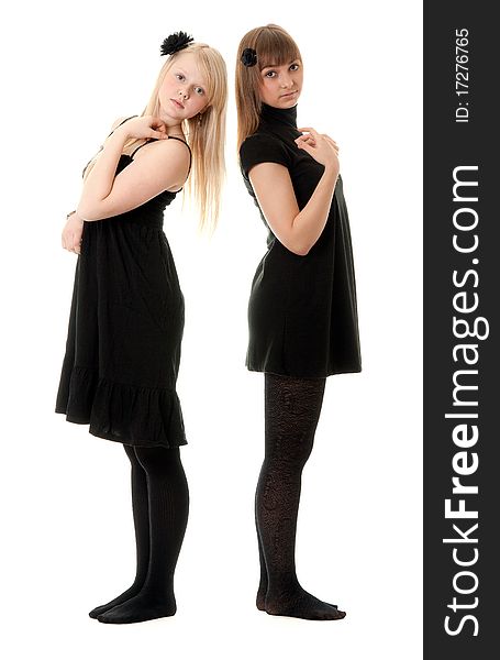 Two girls in black dresses with a white background