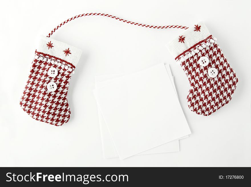 Christmas stockings on a white background are a number of white blank sheets of paper they can write text with congratulations